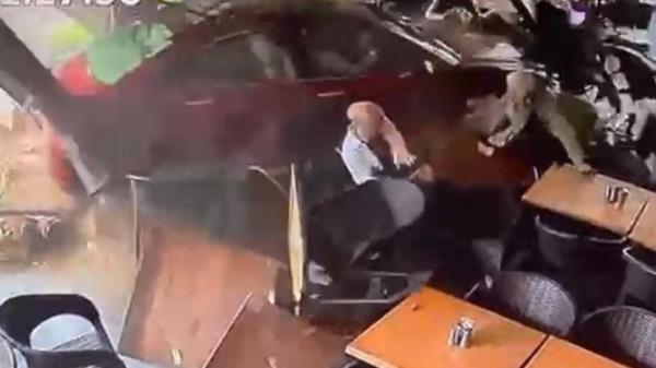 CCTV shows the car accelerating into several diners at the cafe in Bankstown. Supplied CCTV