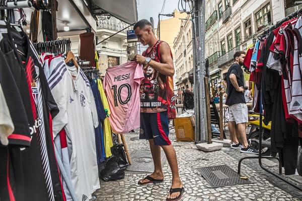 Selling like hot cakes: A shopkeeper with a Messi jersey at a shop in Rio de Janeiro.