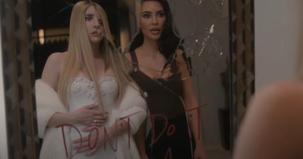 American Horror Story's Emma Roberts and Kim Kardashian looking in a broken mirror with the words don't do it written on it