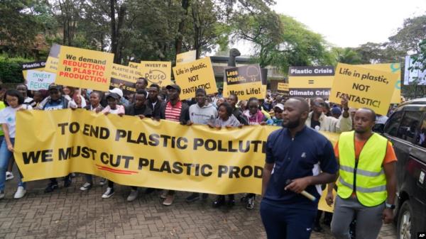 Climate activists carry banners and placards calling for a reduction in global plastic production ahead of the Intergovernmental Negotiating Committee on Plastic Pollution which will take place Nov. 13-19, in Nairobi, Nov. 11, ,2023. 