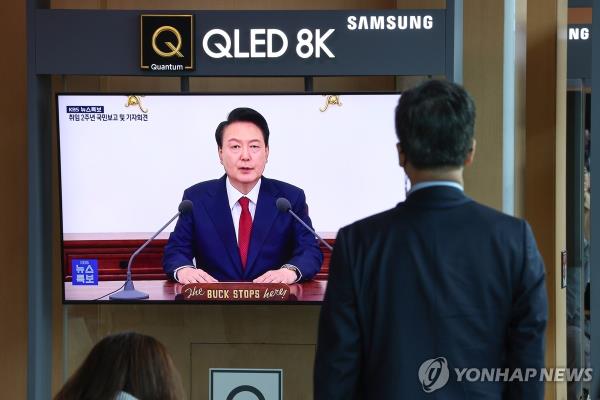 A man watches President Yoon Suk Yeol's address to the nation marking the second anniversary of his presidency at Seoul Station in Seoul on May 9, 2024. (Yonhap)