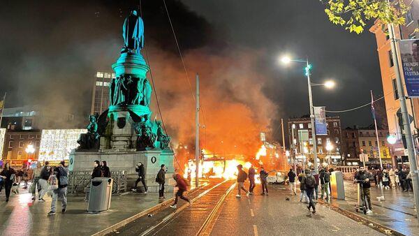Vehicles burnt out and shops looted in Dublin as protesters clash with gardaí following knife attack
