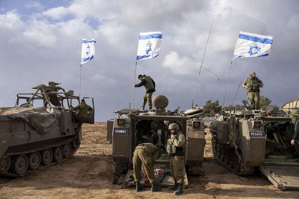 Israeli soldiers work on armored military vehicles along Israel's border with the Gaza Strip, in southern Israel, on Monday, Nov. 20, 2023. Picture: AP Photo/Ohad Zwigenberg