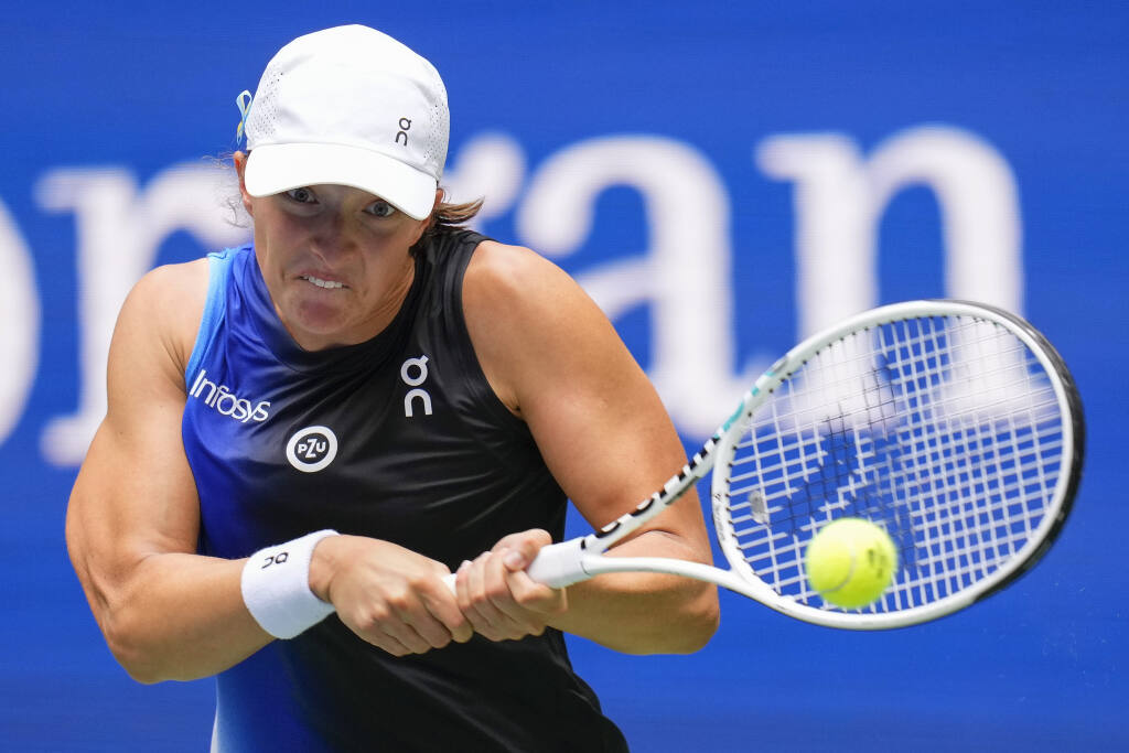 Iga Swiatek, of Poland, returns a shot to Rebecca Peterson, of Sweden, during the first round of the U.S. Open tennis championships, Monday, Aug. 28, 2023, in New York. (AP Photo/Manu Fernandez)