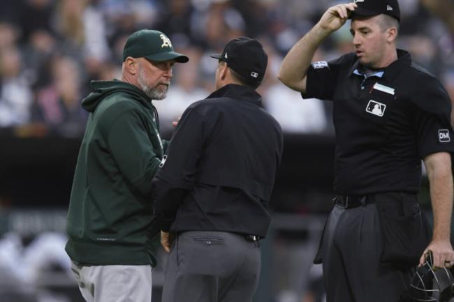 Oakland Athletics manager Mark Kotsay left, argues with umpires during the third inning against the White Sox on Saturday, Aug. 26, 2023, in Chicago. (Paul Beaty / ASSOCIATED PRESS)