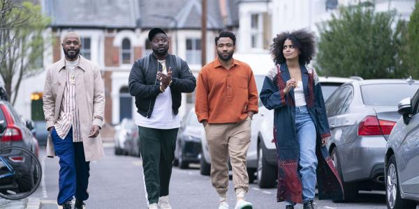 The cast of Atlanta walking in a line down the street