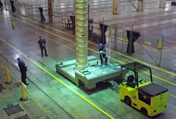 A crew at Centrus Energy's facility in Piketon, Ohio, prepares to lift one of its state-of-the-art centrifuges for making HALEU fuel from a transport cart.